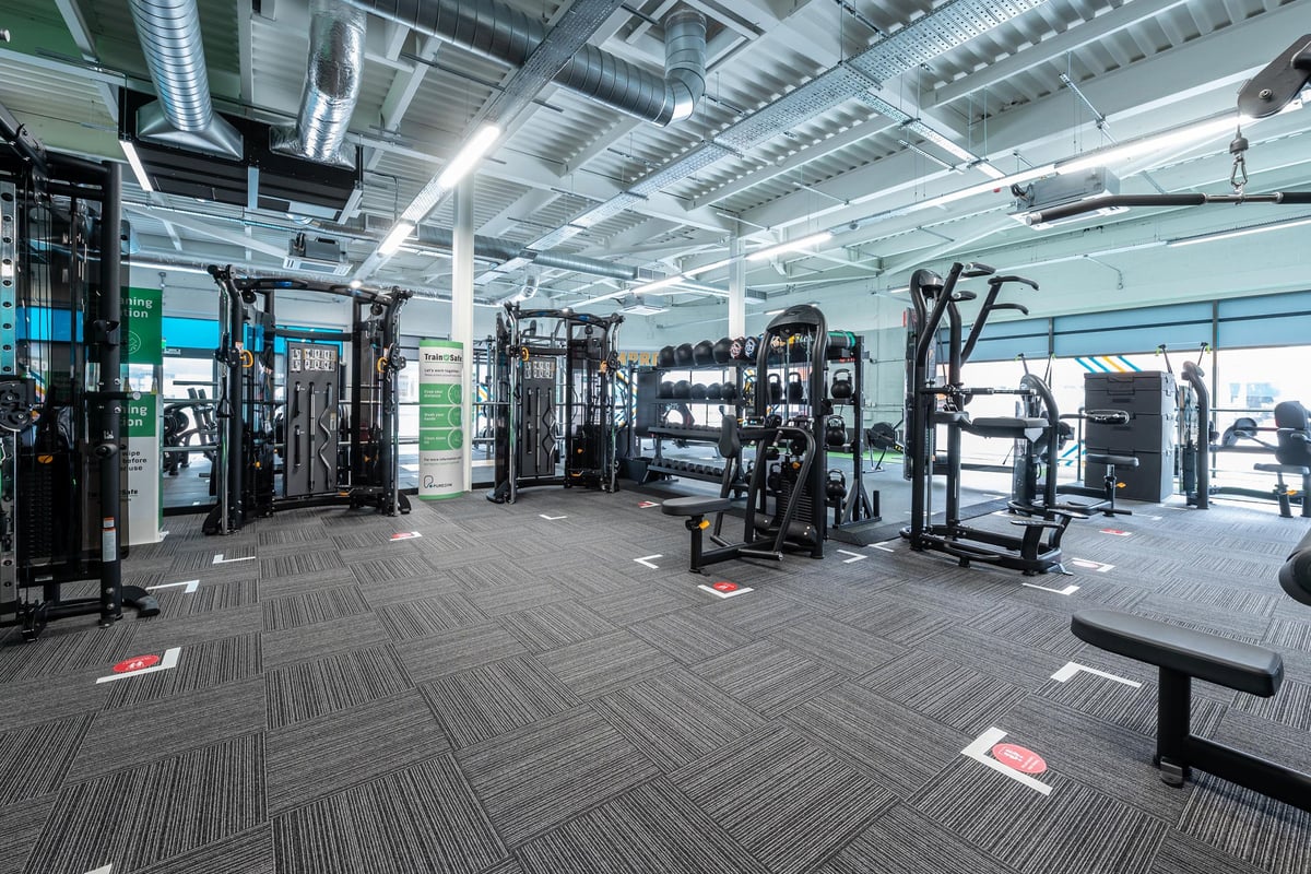 PureGym Aldershot Westgate Retail Park: Resistance machines, squat racks, and weight benches in a spacious training area.