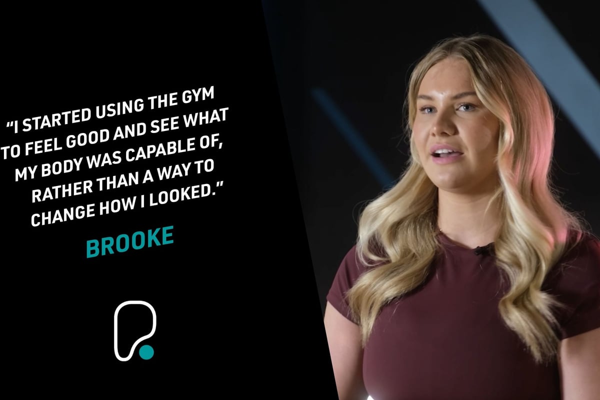 Blonde woman in maroon top speaking with a quote about gym motivation beside her.