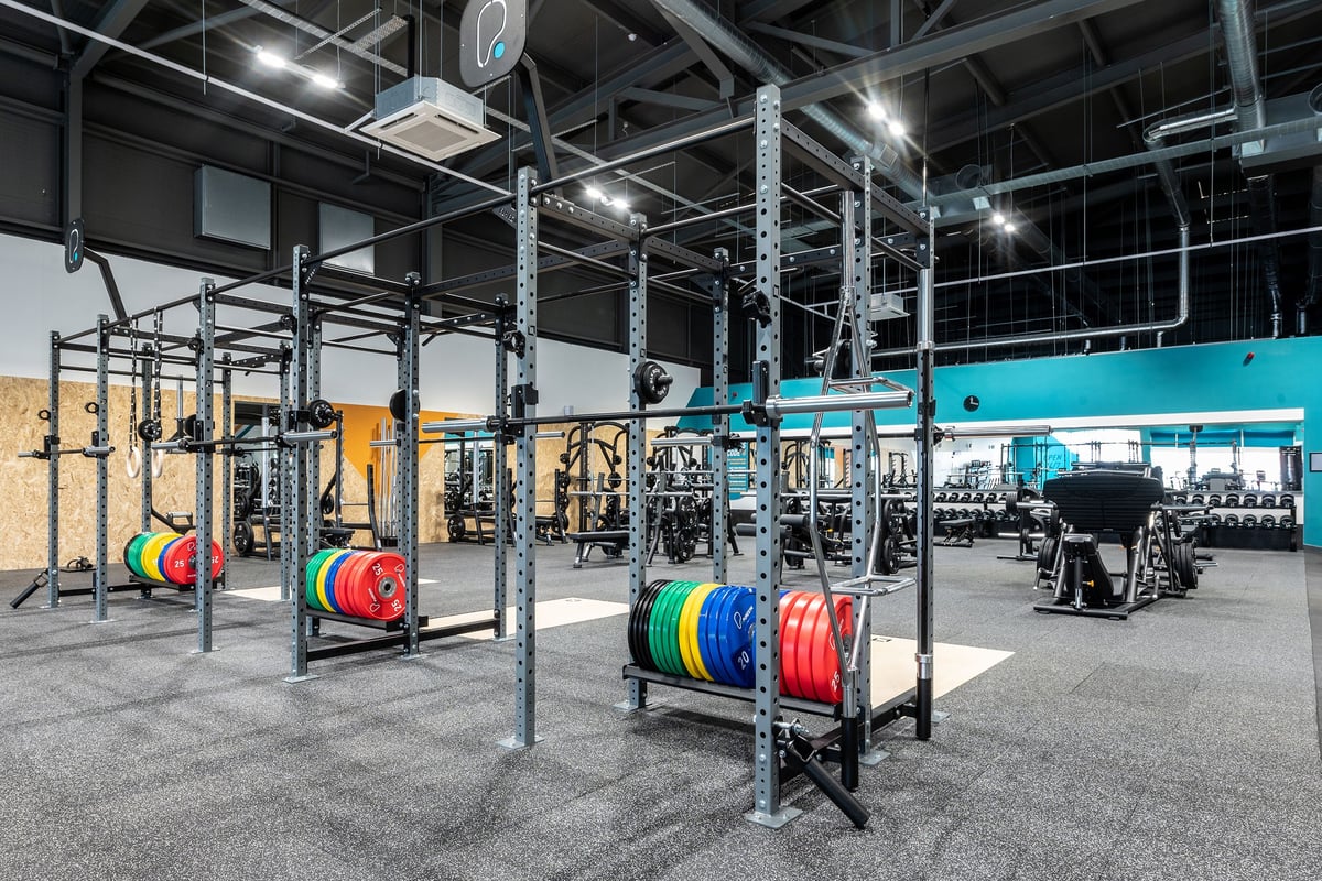 PureGym Walsall Crown Wharf: Squat racks, weight plates in various colours, weightlifting platforms, and rubberized flooring.
