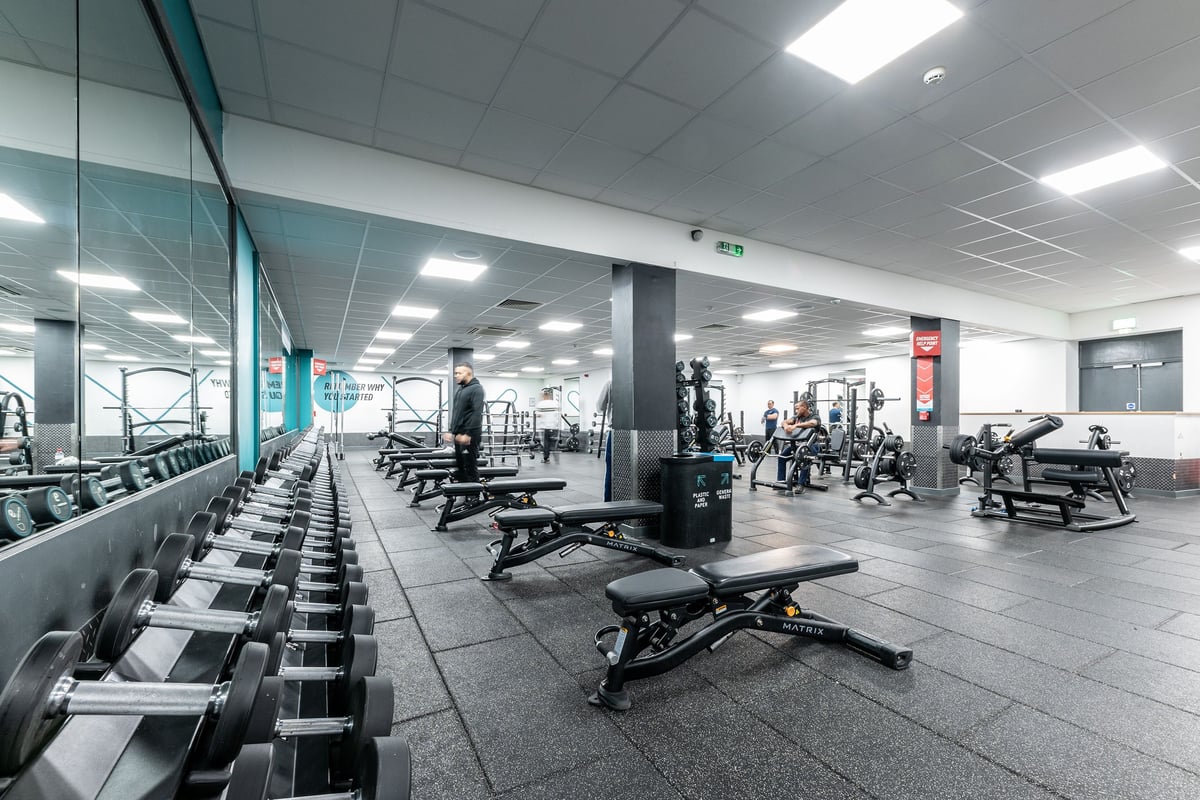 PureGym Luton And Dunstable: Rows of weight benches, dumbbell racks, lifting platforms, and exercise machines.