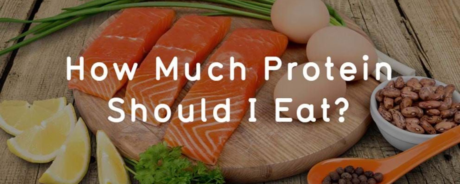 Three salmon fillets, three eggs, green onions, lemon wedges, parsley, beans, and pepperco