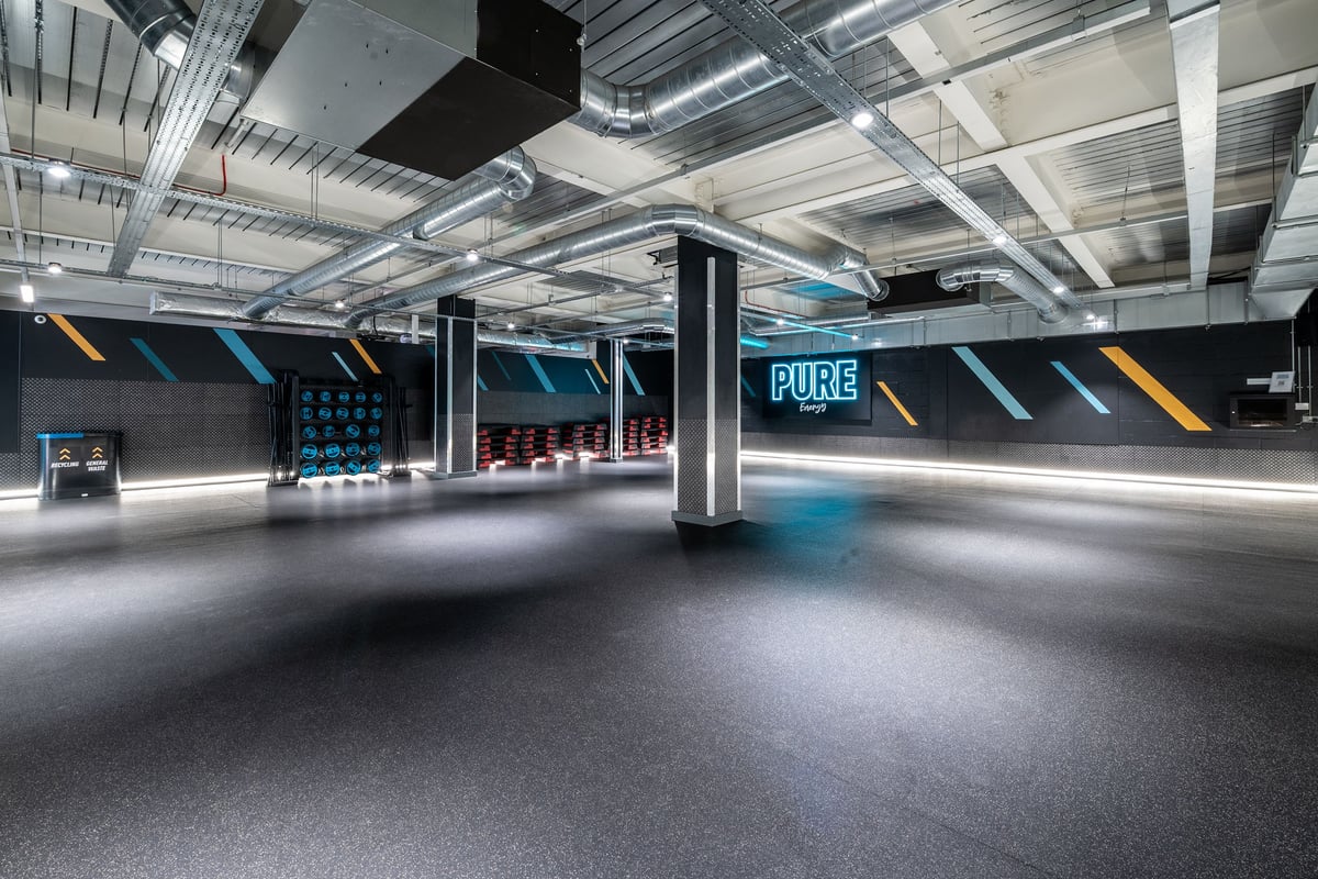 PureGym London Orpington Central: Modern gym interior with treadmills, weight racks, tubing equipment, and branded signage.