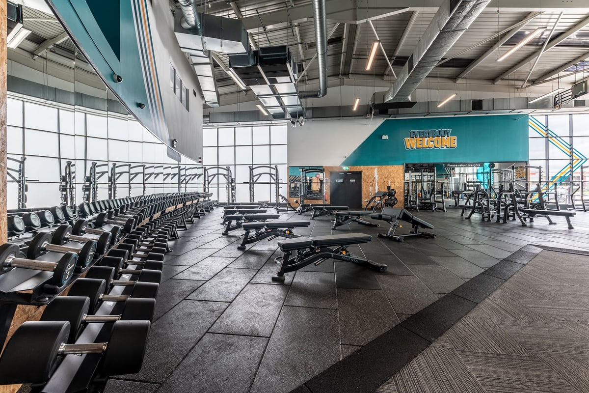 PureGym Brierley Hill: Rows of stationary bikes, treadmills, benches, free weights, and weight machines.