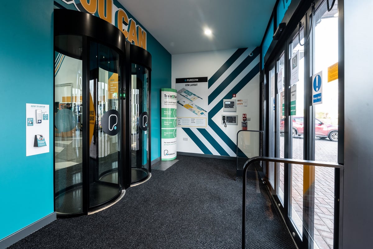 PureGym Yeovil Houndstone Retail Park: Glass fronted entrance area with signage and information displays.