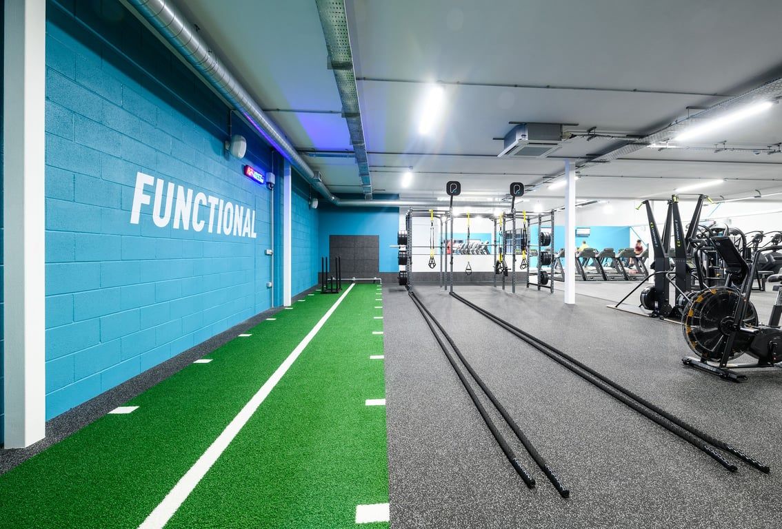 PureGym Cardiff Bay: Functional training area with turf track, battle ropes, weighted sleds.