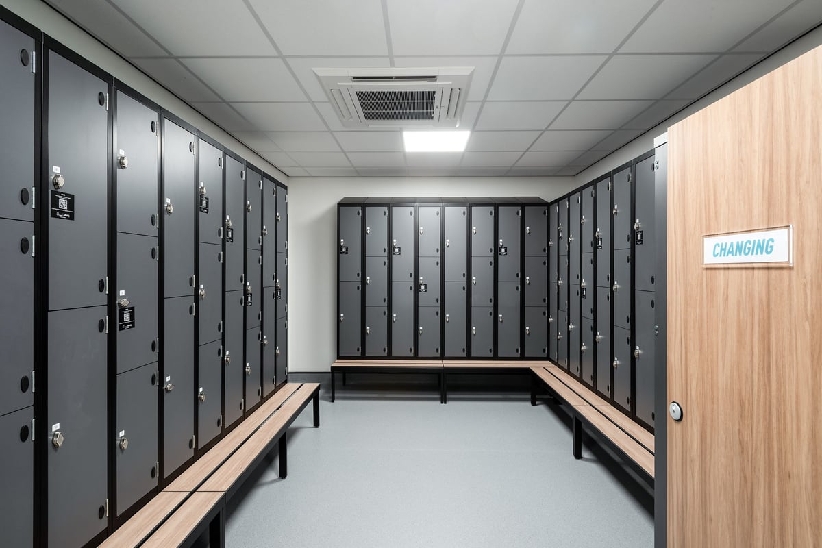 PureGym Cannock Orbital Retail Park: Lockers, benches, and a sign indicating a changing area.