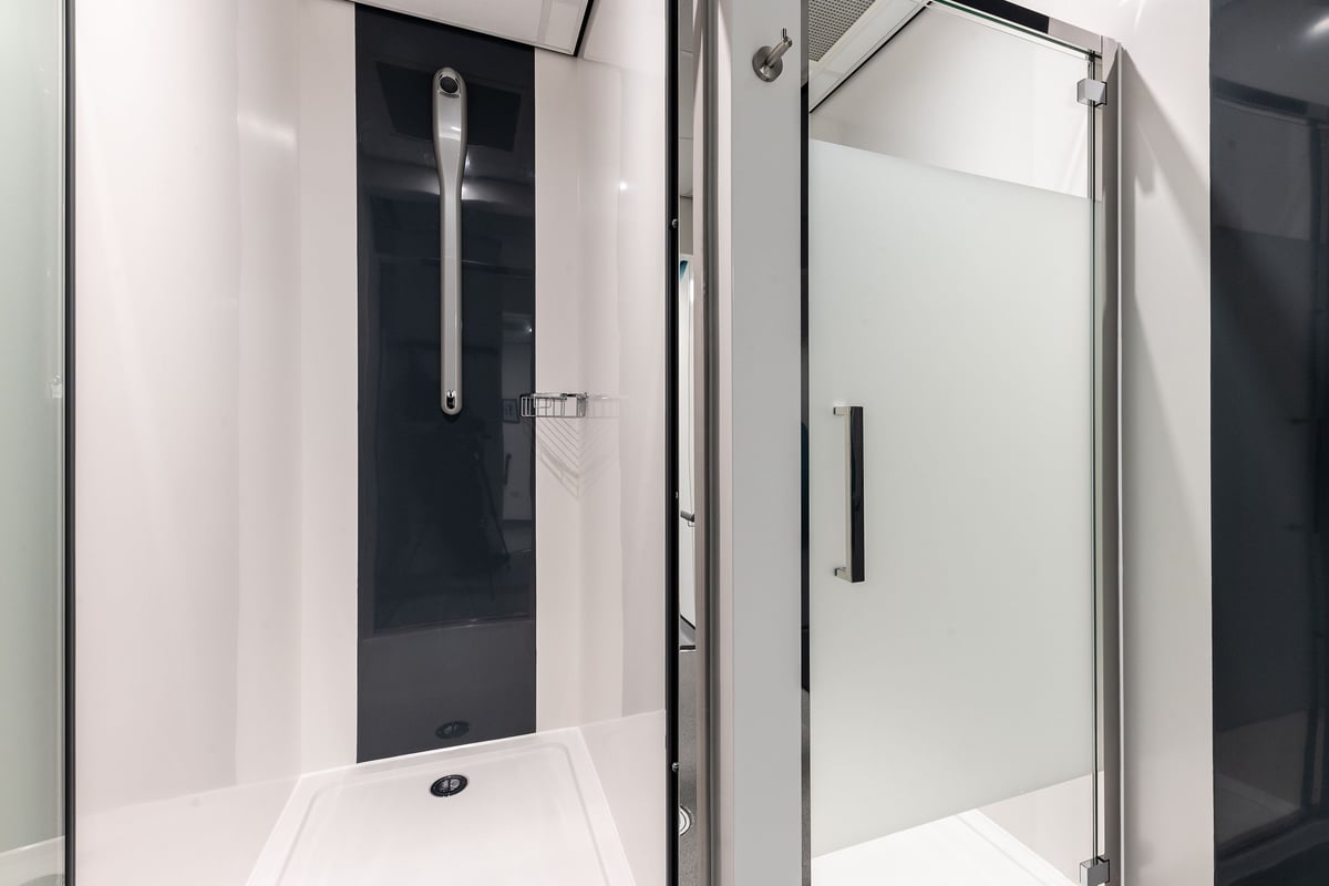 PureGym Selby: Glass shower enclosures, shower heads, and tiled flooring.