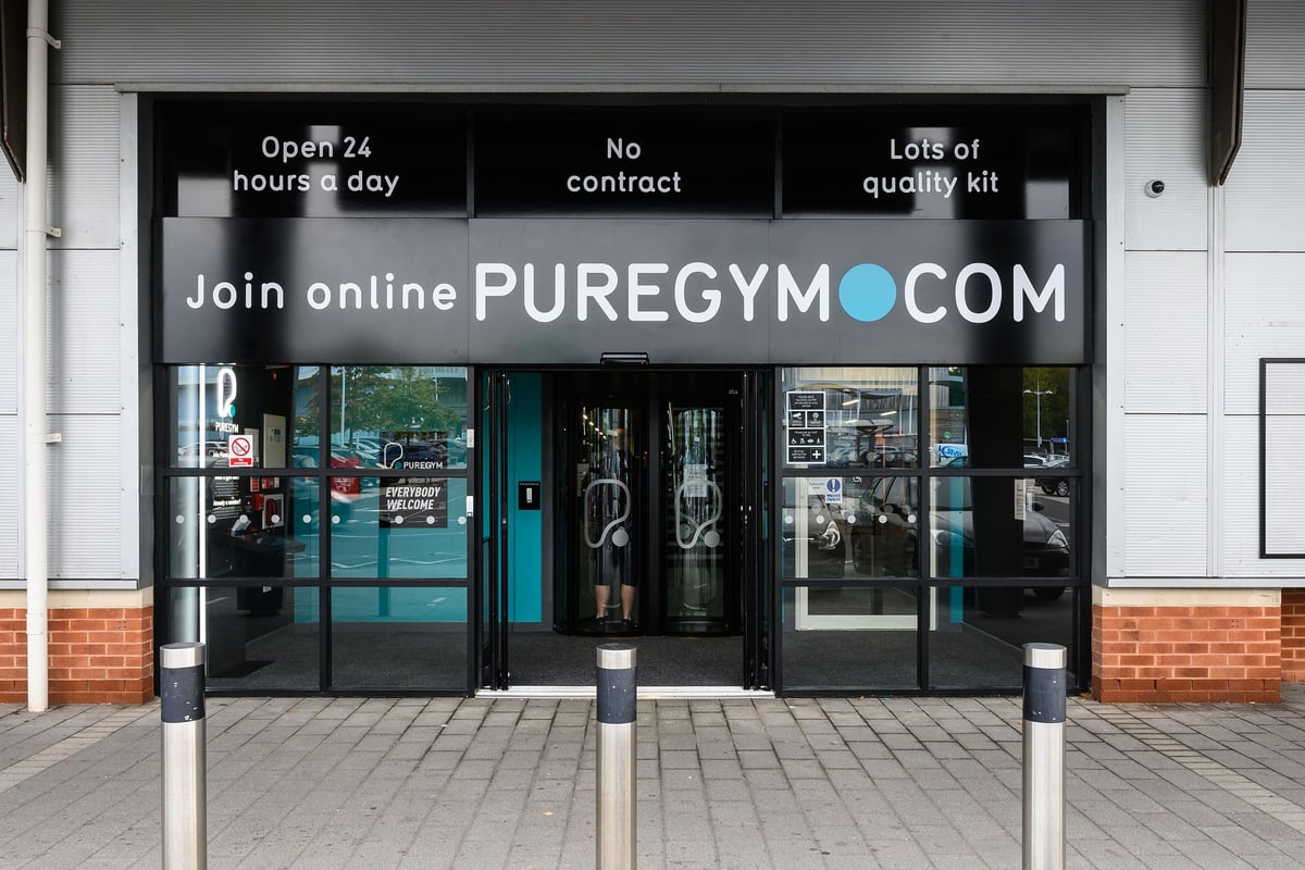 PureGym Bristol Abbey Wood Retail Park: Gym entrance with glass doors, no fitness equipment visible inside.