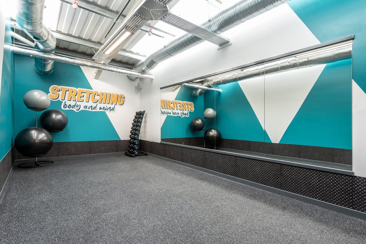 PureGym Grantham Discovery Retail Park: Stretching area with stability balls, medicine balls, and rubberized flooring.