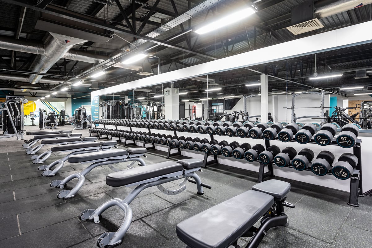 PureGym Bradford Idle - benches and free weights in a gym