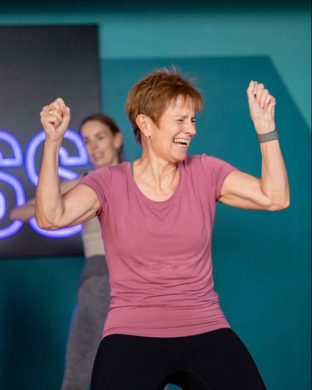 Smiling PureGym member taking part in a Dance class
