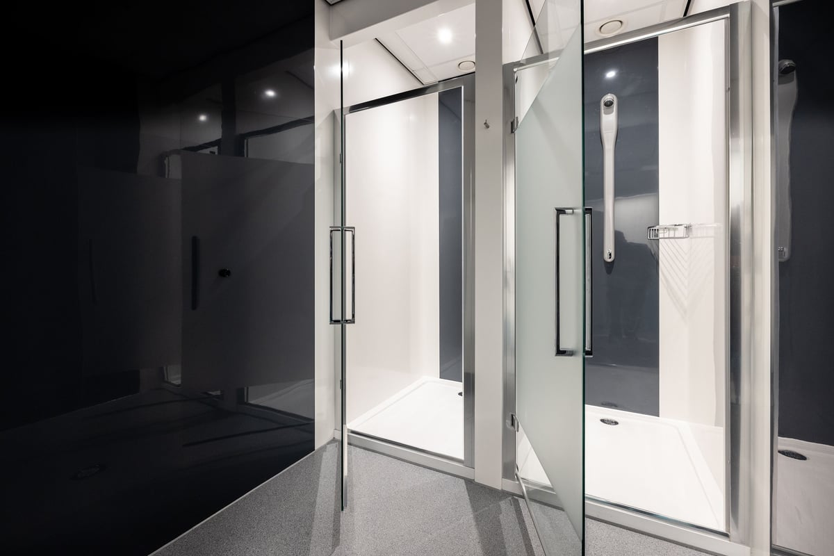 PureGym Washington: Shower cubicles with glass doors, tiled walls and floors.