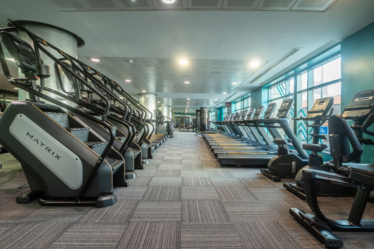 PureGym Edinburgh Exchange Crescent: Rows of treadmills and elliptical trainers in a modern gym facility.