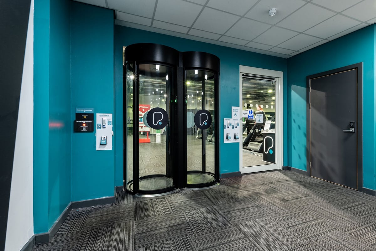 PureGym Lincoln St Marks Centre: Refrigerated vending machines, access controls, and a teal-colored entryway or corridor.