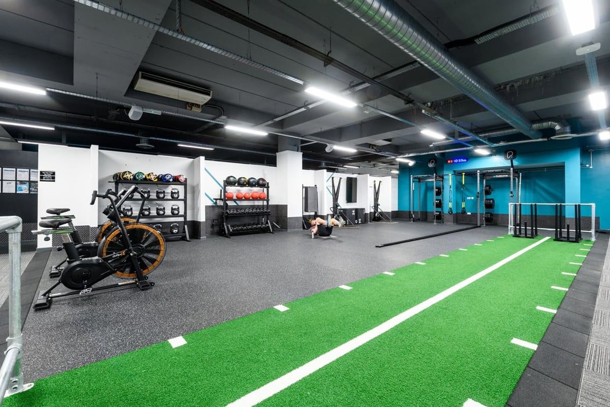 PureGym Bournemouth The Triangle: Squat racks, turf area, resistance machines, and free weights in a modern gym setting.