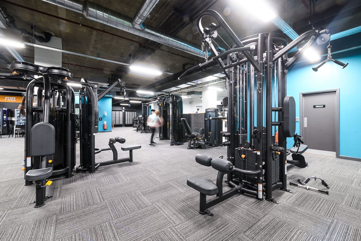 PureGym London Tottenham Court Road: Weight machines, free weights, benches, and rubberized flooring in a gym studio setting.