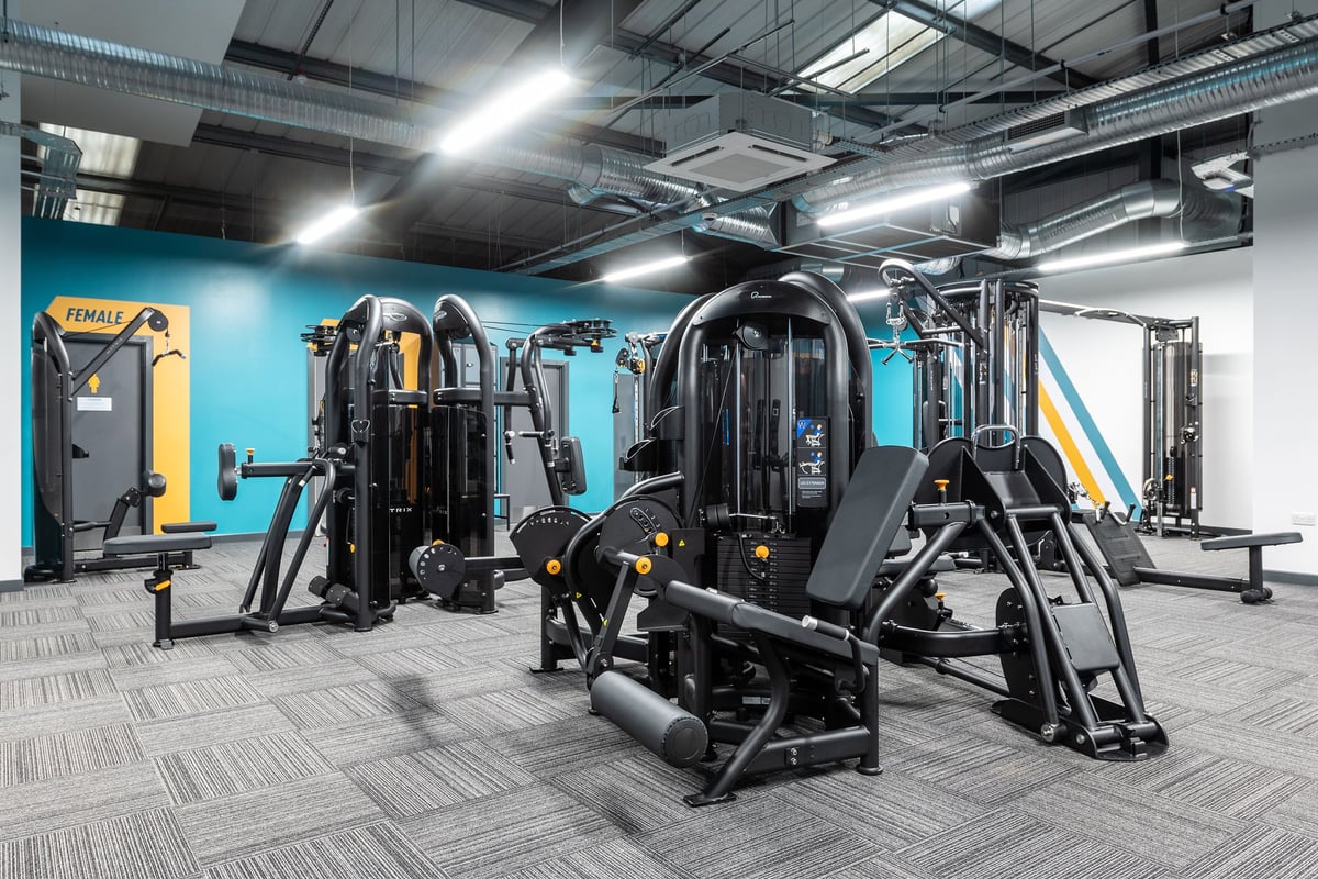 PureGym Letchworth: Resistance machines, weight stacks, benches, and rubberized floor in a brightly lit gym area.