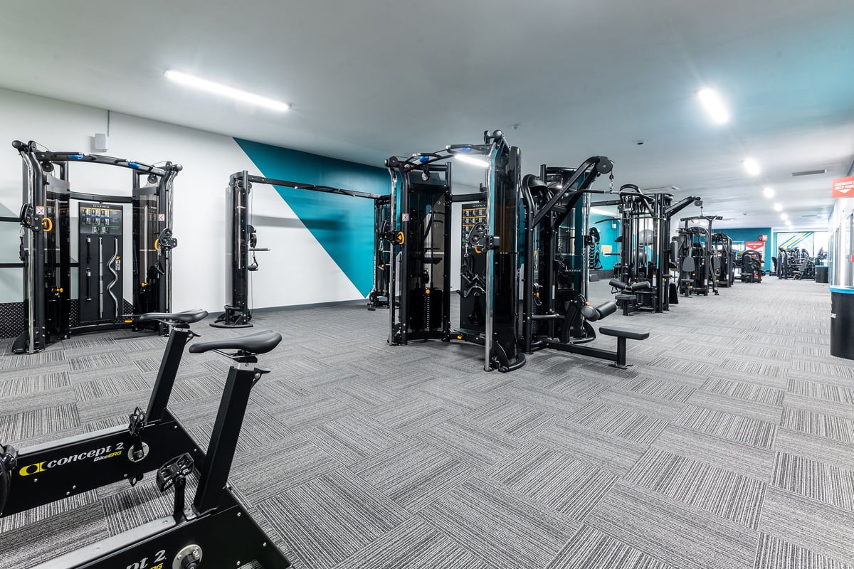 PureGym Selby: Rows of weight training machines, benches, and rubberized flooring in a modern gym setting.