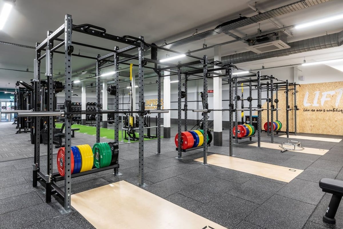 PureGym Derby Kingsway Retail Park: Squat racks, weight plates, strength training equipment, and rubberized gym flooring.