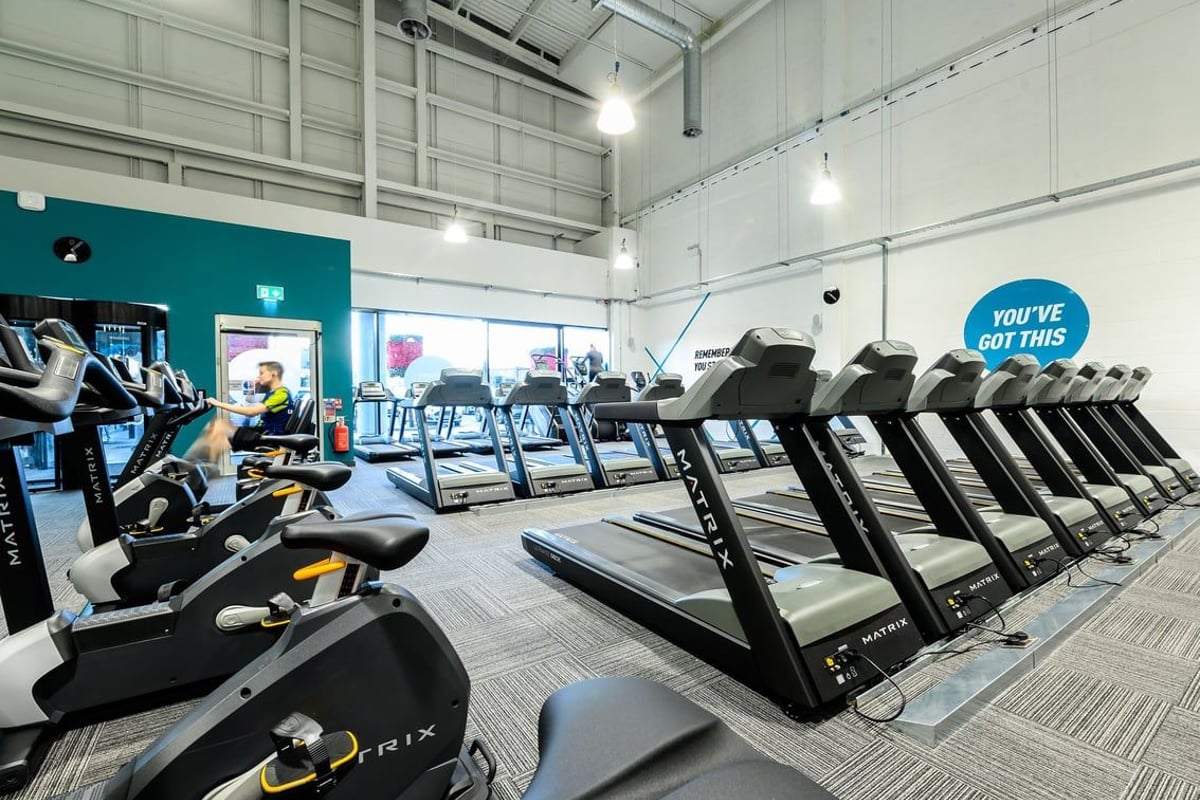 PureGym Romford: Rows of treadmills, exercise bikes, and weight machines in a brightly lit gym interior.