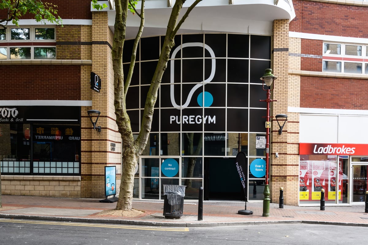 PureGym Birmingham Arcadian Centre: Gym storefront with branding, cycle parking stands outside.