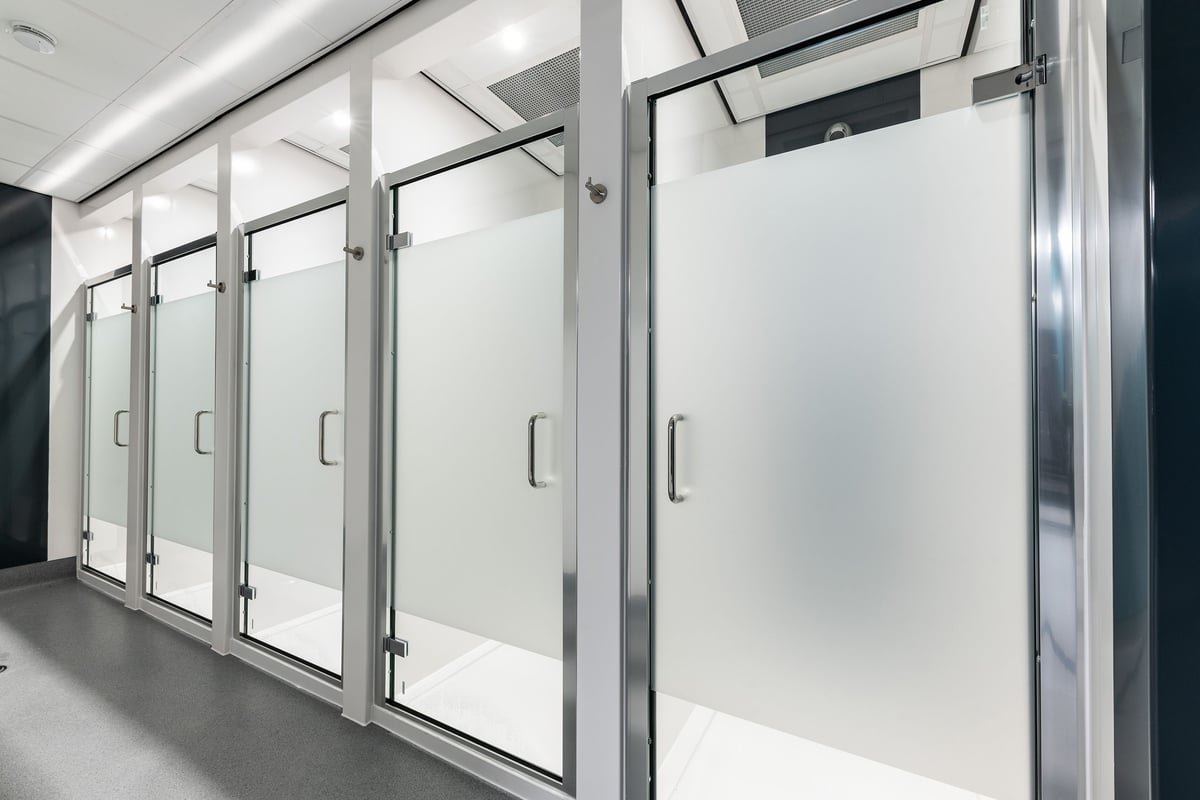 PureGym Manchester First Street: Rows of upright refrigerator-style metal doors or lockers with glass fronts.