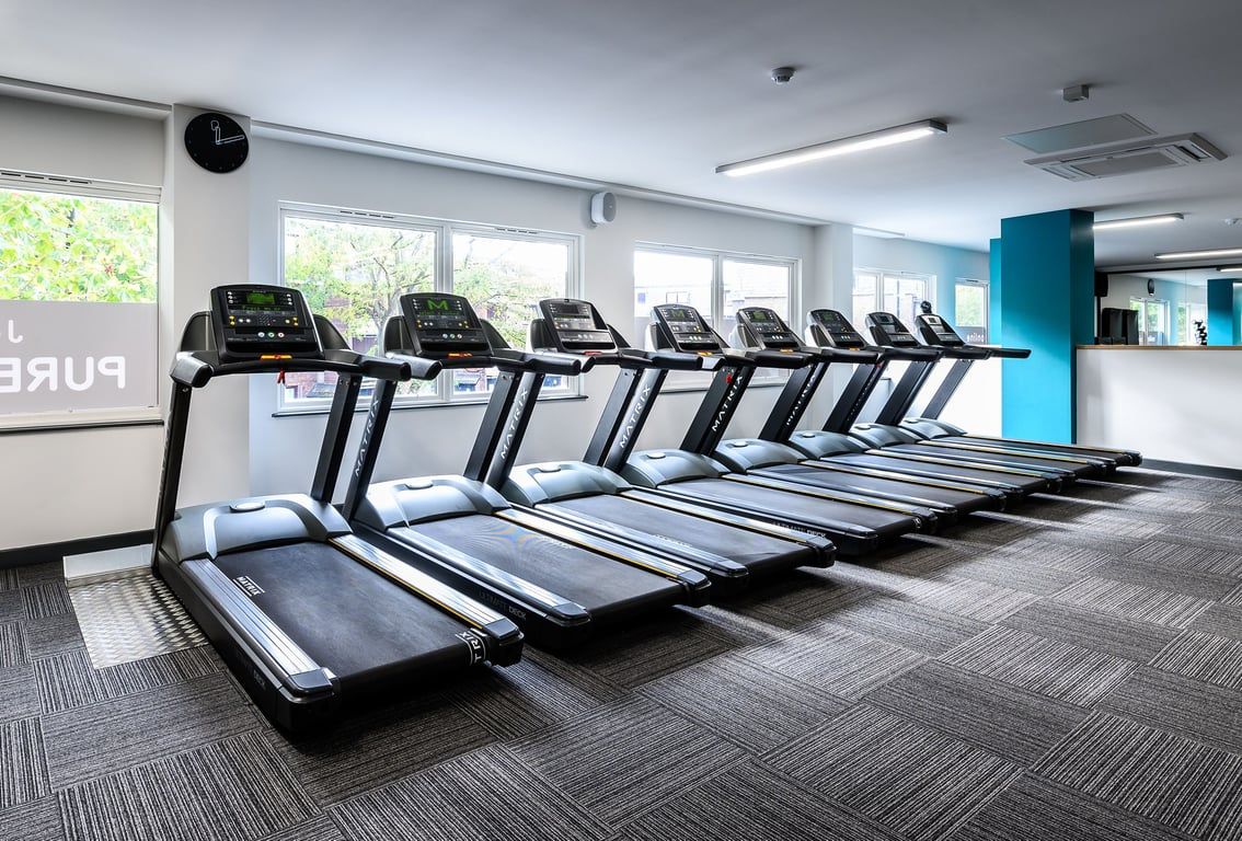 PureGym London Camberwell Southampton Way: Rows of modern treadmills lined up in a well-lit gym interior.