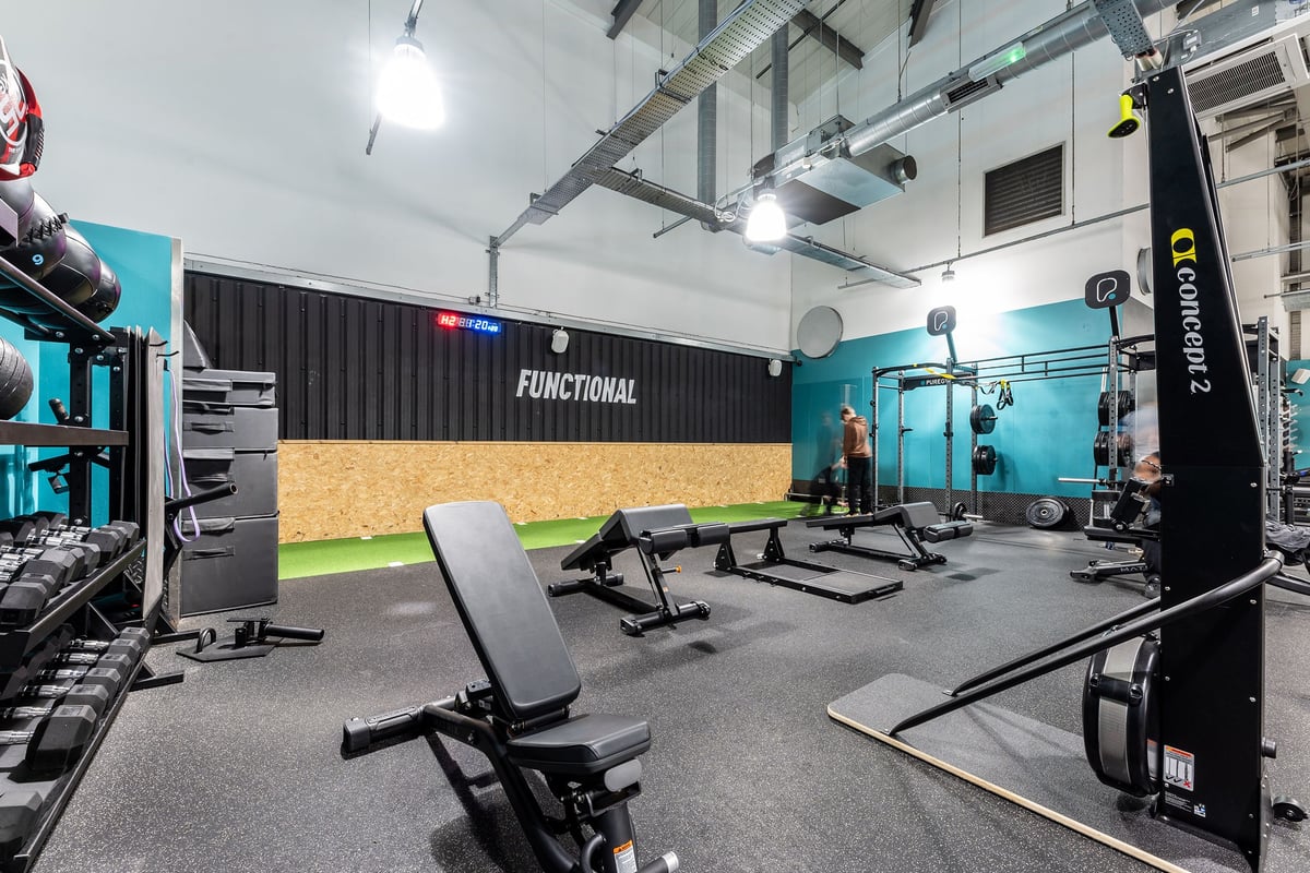 PureGym Wolverhampton Bentley Bridge: Weight benches, squat racks and resistance bands in a functional training area.