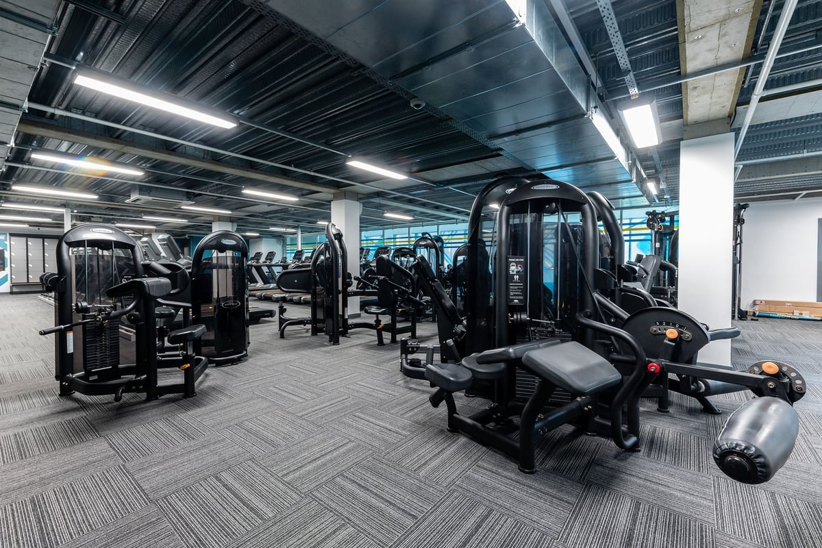 PureGym Newcastle Eldon Garden: Weight machines, treadmills, free weights, and rubberized flooring in a gym facility.