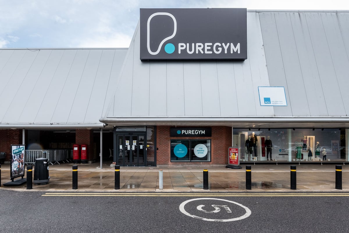 PureGym Reading Calcot: Exterior of gym premises with branding, signage, and parking spaces visible.