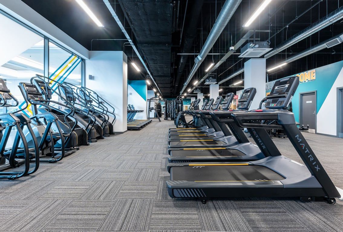 PureGym Hatfield: Rows of treadmills, cross-trainers, and stationary bikes in a modern gym interior.