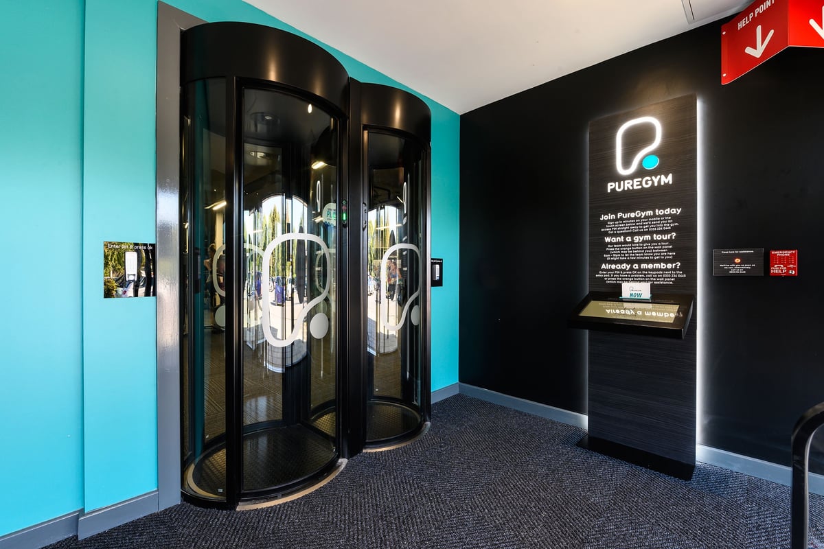 PureGym Salisbury: Two entrance pods with illuminated panels and glass doors.