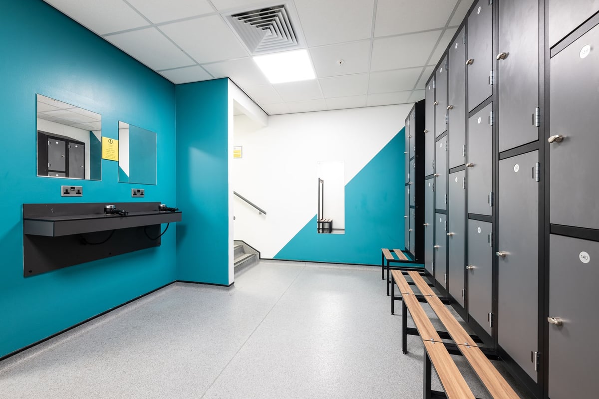PureGym Nuneaton changing room with lockers, bench and mirror
