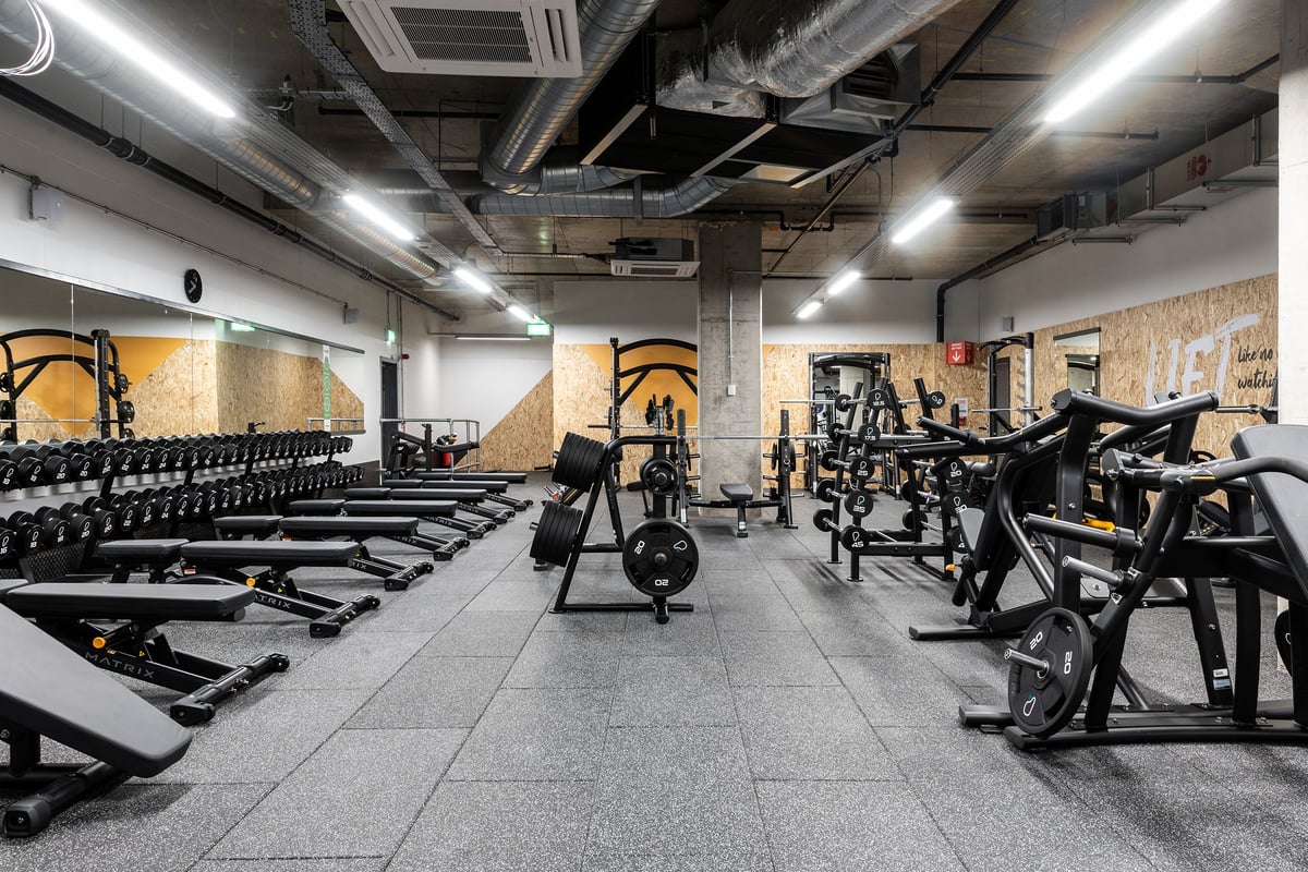 PureGym London Hoxton: Rows of strength equipment like squat racks, weight benches, and free weights on rubberized floors.