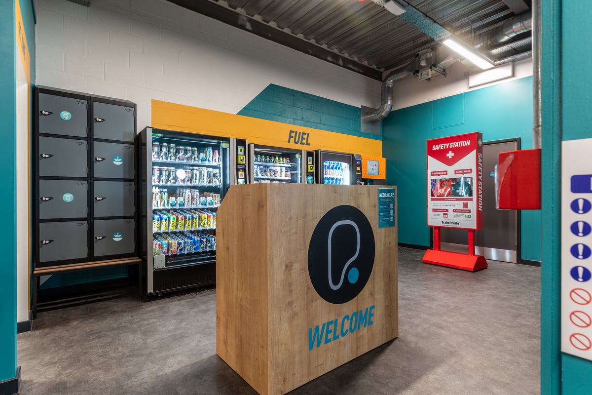 PureGym Plymouth Derriford: Refrigerated vending machines, self-service kiosks, and branded displays inside a gym lobby.