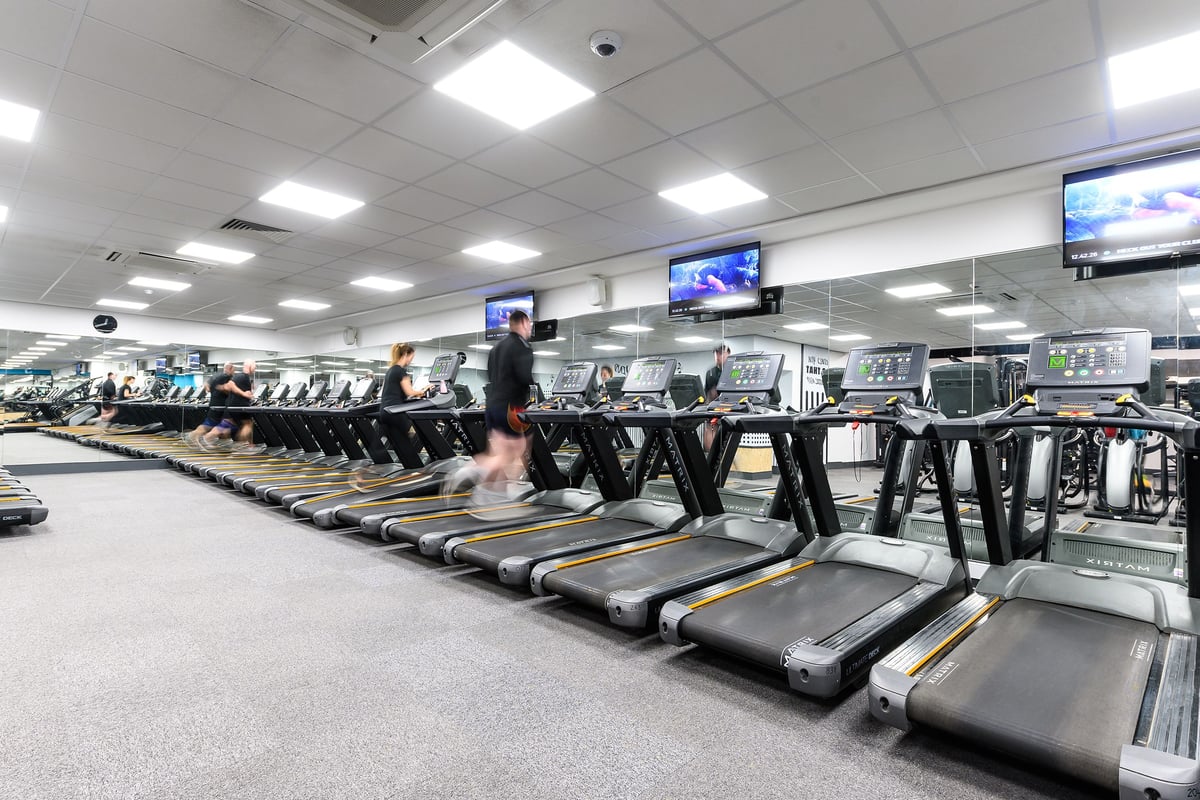 PureGym Oxford Central: Rows of treadmills arranged neatly in a brightly lit gym interior.