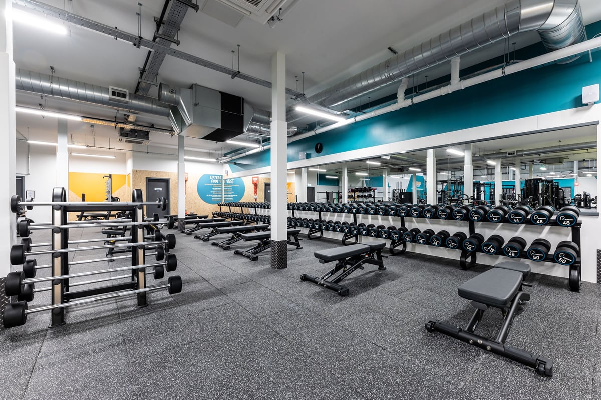 PureGym Dagenham: Rows of weight racks, benches, dumbbells, and free weights on rubberized gym flooring.