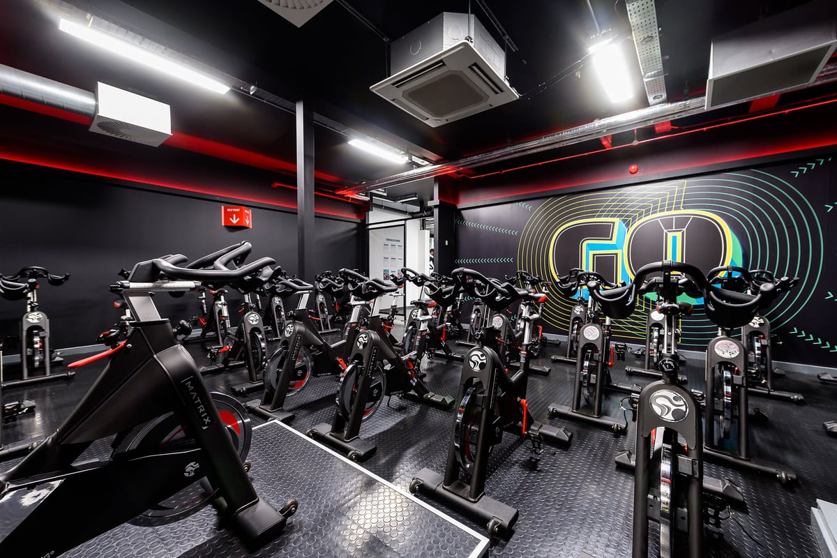 PureGym Oxford Templars Shopping Park: Rows of stationary bikes, treadmills, and weight machines in a modern fitness studio.