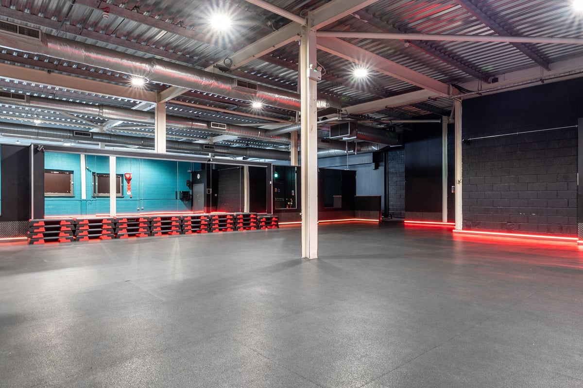PureGym Bristol Union Gate: Boxing area with heavy bags, floor mats, and red safety barriers.