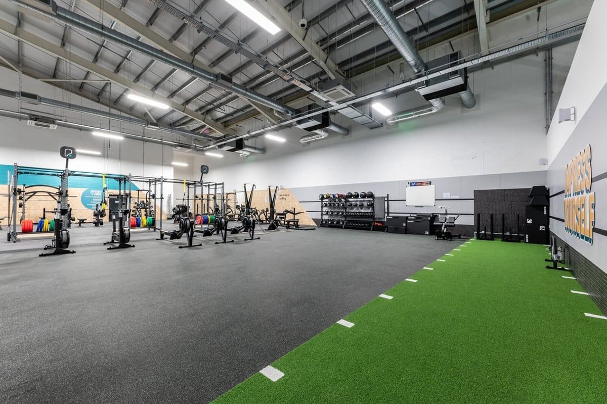 PureGym Lincoln Carlton Centre: Floor space with weightlifting equipment, turf training area and weight racks.