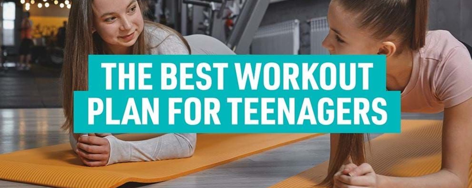 Two teenage girls doing planks on orange mats in a gym with workout text overlay