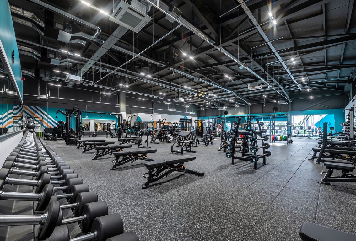 PureGym Walsall Crown Wharf: Weight racks, benches, dumbbells, and rubberized flooring in a large gym space.