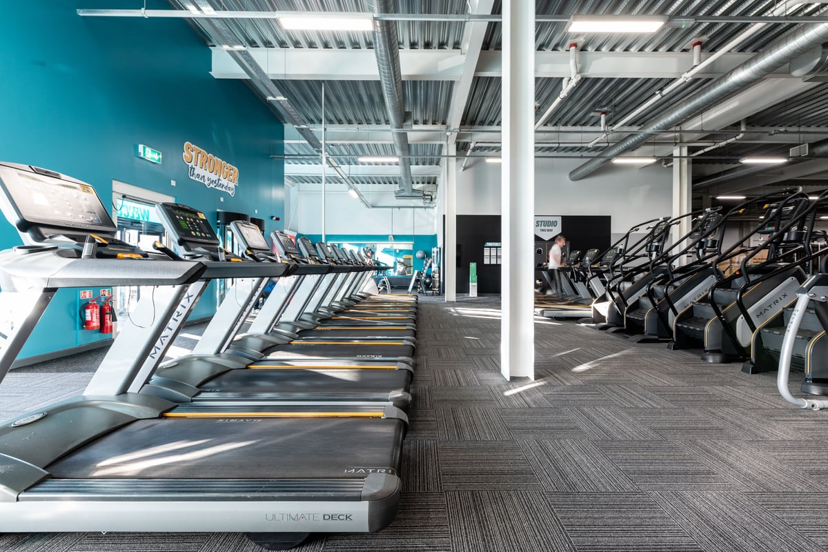 PureGym Hednesford Cannock: Rows of treadmills, ellipticals, and exercise bikes inside a fitness centre.
