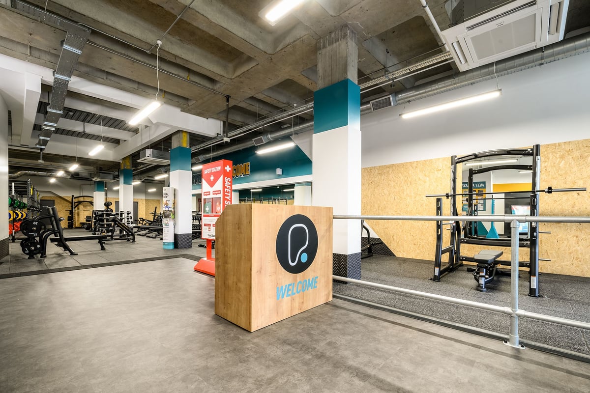PureGym London Wimbledon: Resistance training area with squat racks, weight plates, plyo boxes, and functional training rigs.