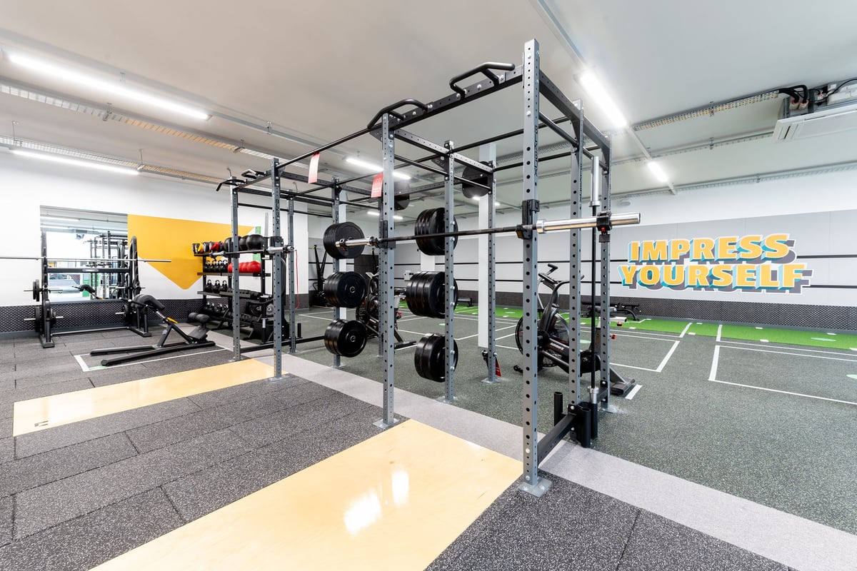 PureGym Colchester Retail Park: Functional training rig, rubberized turf, weight racks, mirrors, storage for accessories.