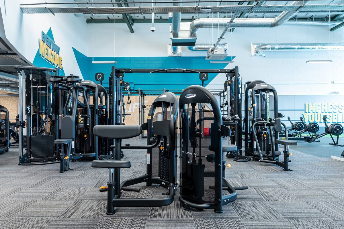 PureGym Coleraine: Resistance machines, weight stacks, benches, and rubberized flooring in a gym studio.