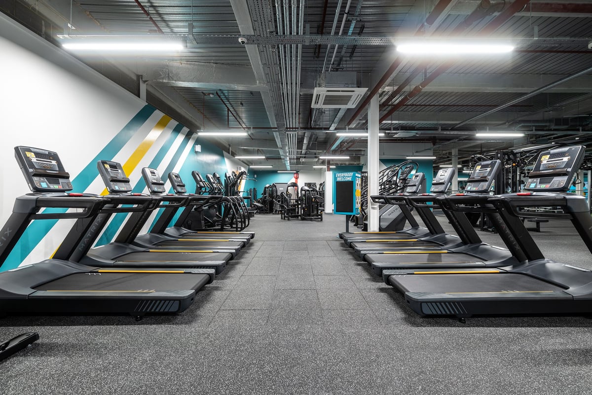 PureGym Erith: Rows of treadmills in a modern gym facility.