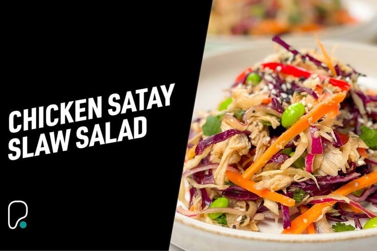 Chicken satay slaw salad with shredded chicken, red cabbage, carrots, and edamame beans