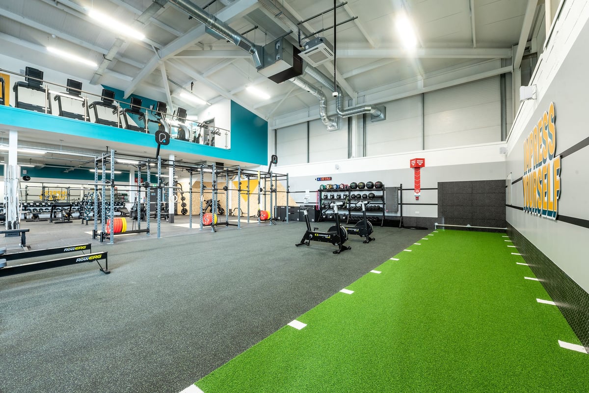 PureGym Trowbridge: Weight racks, resistance machines, free weights, turf area, mirrors, and rubberised flooring.