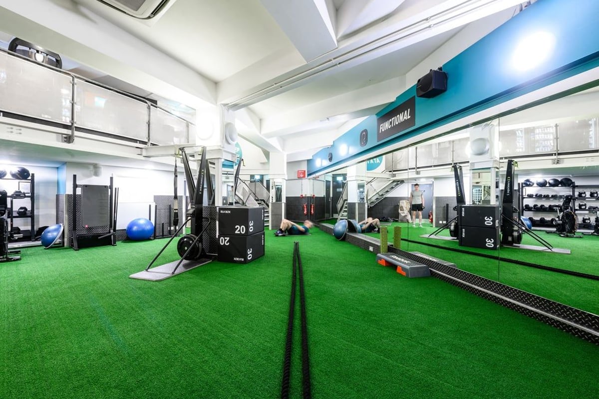 PureGym London St Pauls: Strength training area with turf flooring, weight racks, resistance machines, and wall mirrors.